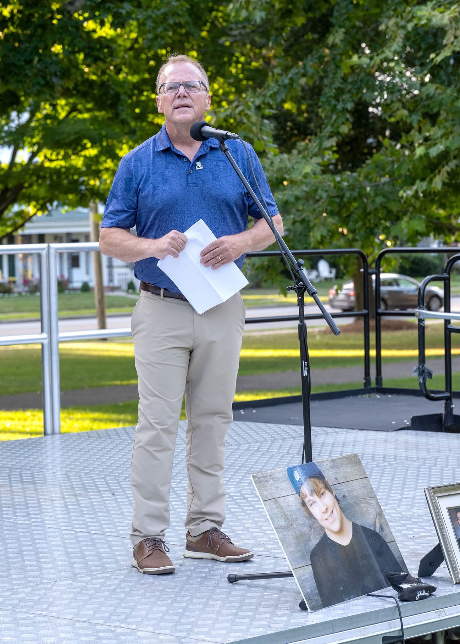 IOAD Organizer James Derick speaks at a recent event with a picture of his son, Jack, in the foreground.