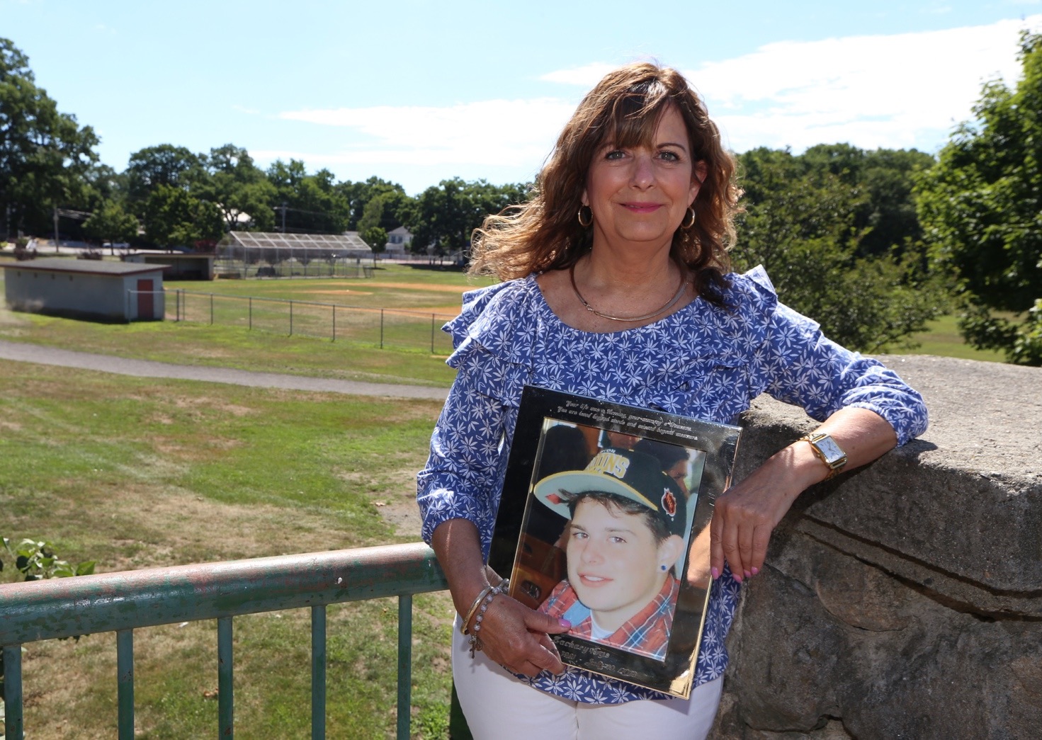 Louise Griffin holding a photo of her son, Zachary