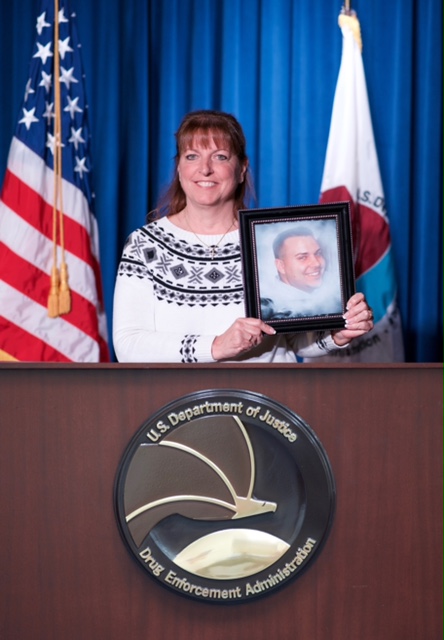 Cheryl Juaire holds a photo of Corey at the Dept. Of Justice