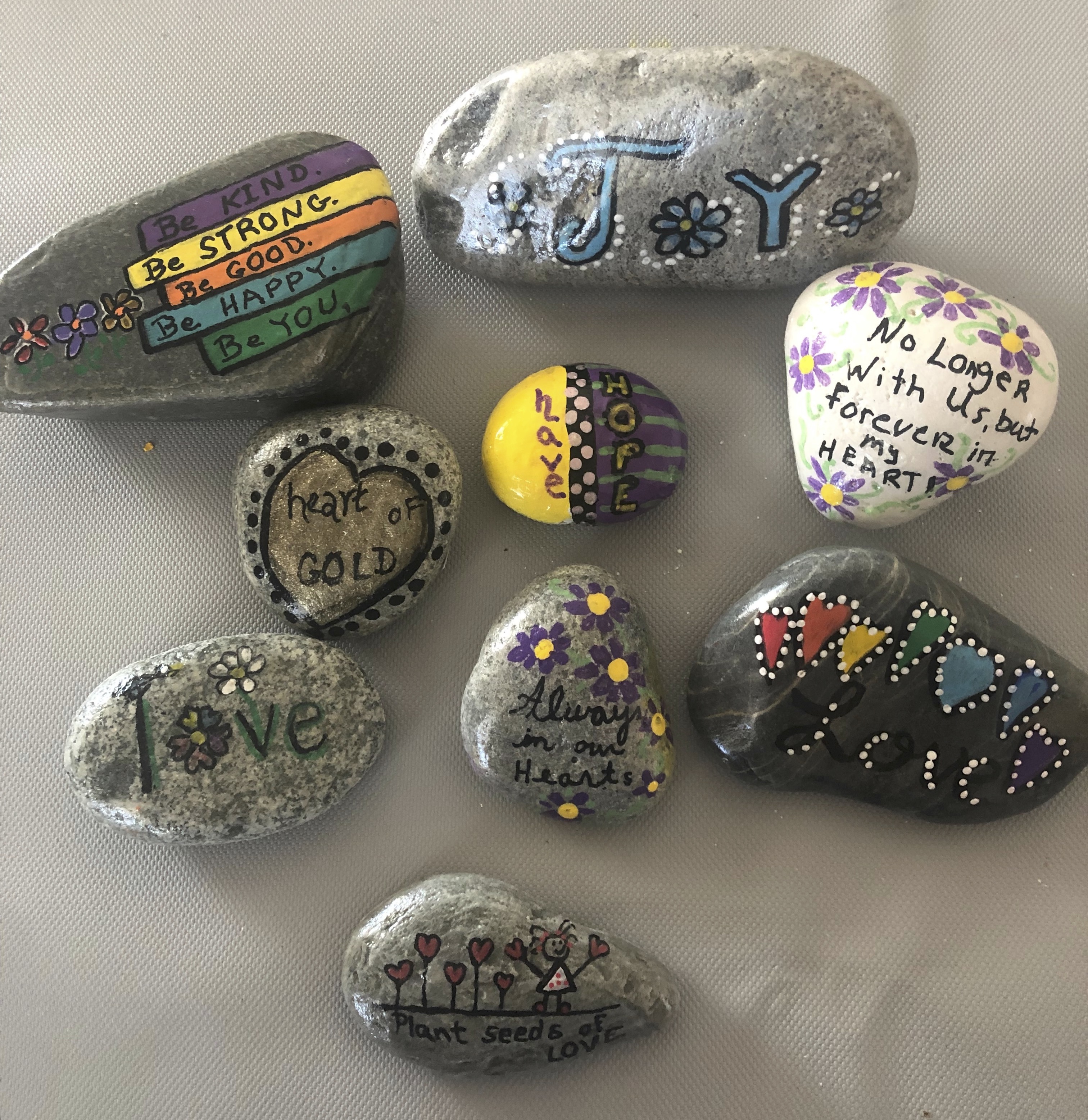 Kindness rocks painted by this month’s featured peer grief helper, Jill Laganas